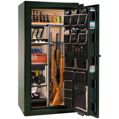 Premium interior of the Liberty Magnum 25 gun safe paired with the Emerald Green feathered edge finish, featuring adjustable shelving, door organizer, long gun storage, and deluxe interior configuration.